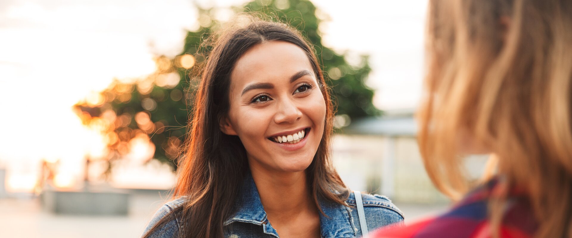 Close up of a smiling asian woman talking to her girl | Vadym Drobot