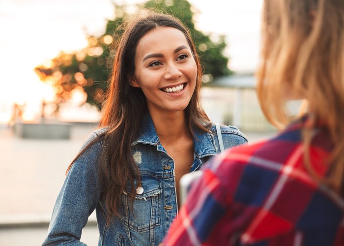Close up of a smiling asian woman talking to her girl | Vadym Drobot